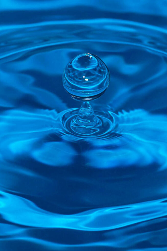 A single drop falling into calm water